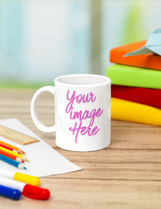 15 oz personalized ceramic mug with custom text displayed on a desk with books and stationery